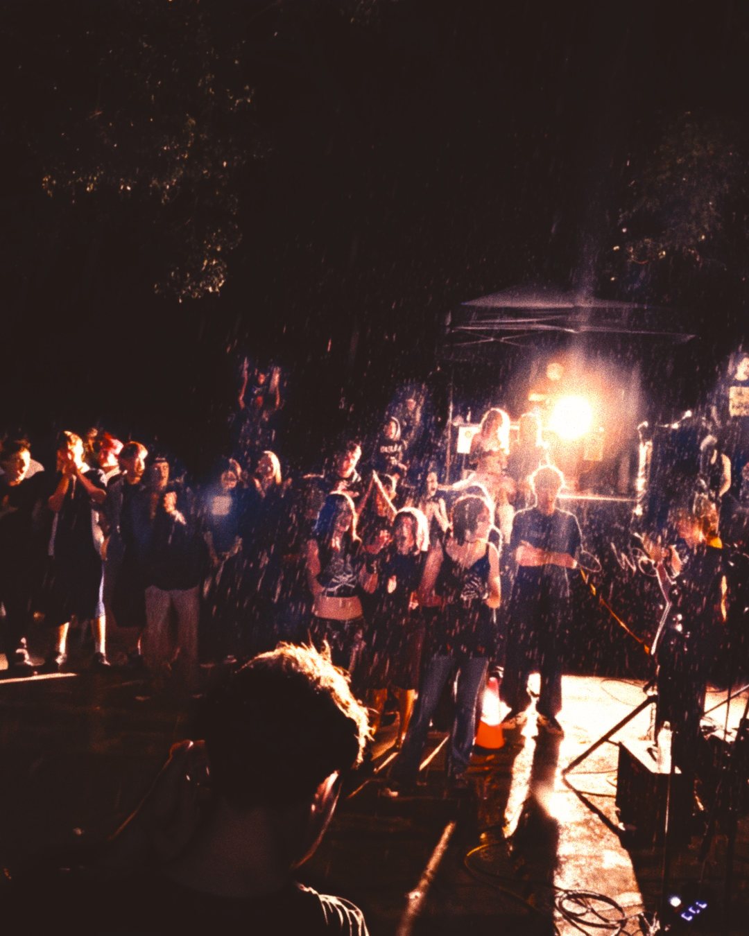 The crowd at Punk in the Park in the rain, floodlit, Thornlands skatepark